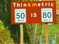 Think metric sign going into Canada