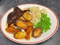 Dinner this evening: Lamb steak in a red wine reduction, with roast potatoes, peas and buttered celeriac mash.